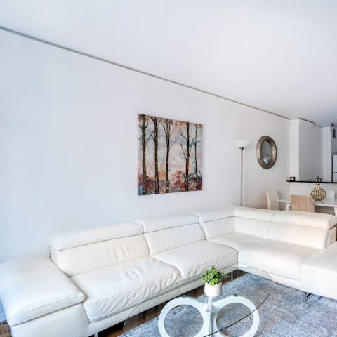 Stretch out on the white L-shaped sofa after a busy day exploring